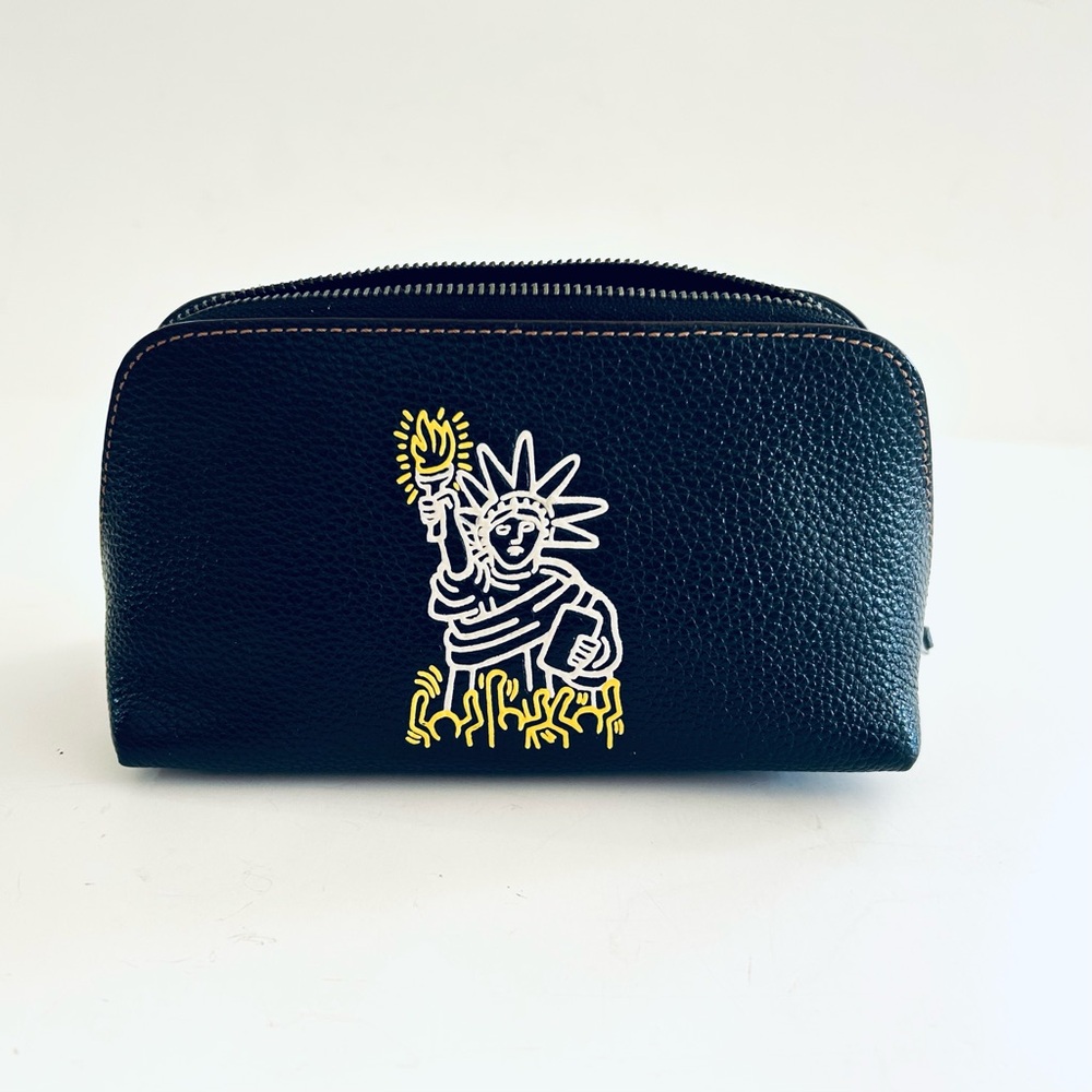 Coach Pebble Leather Dome Pouch by Keith Haring features the Statue of Liberty